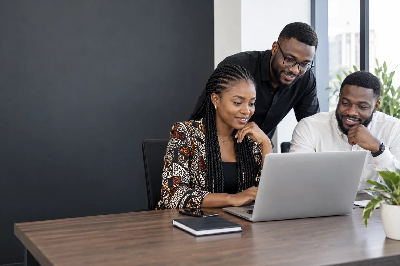 African founders collaborating on a product at a laptop